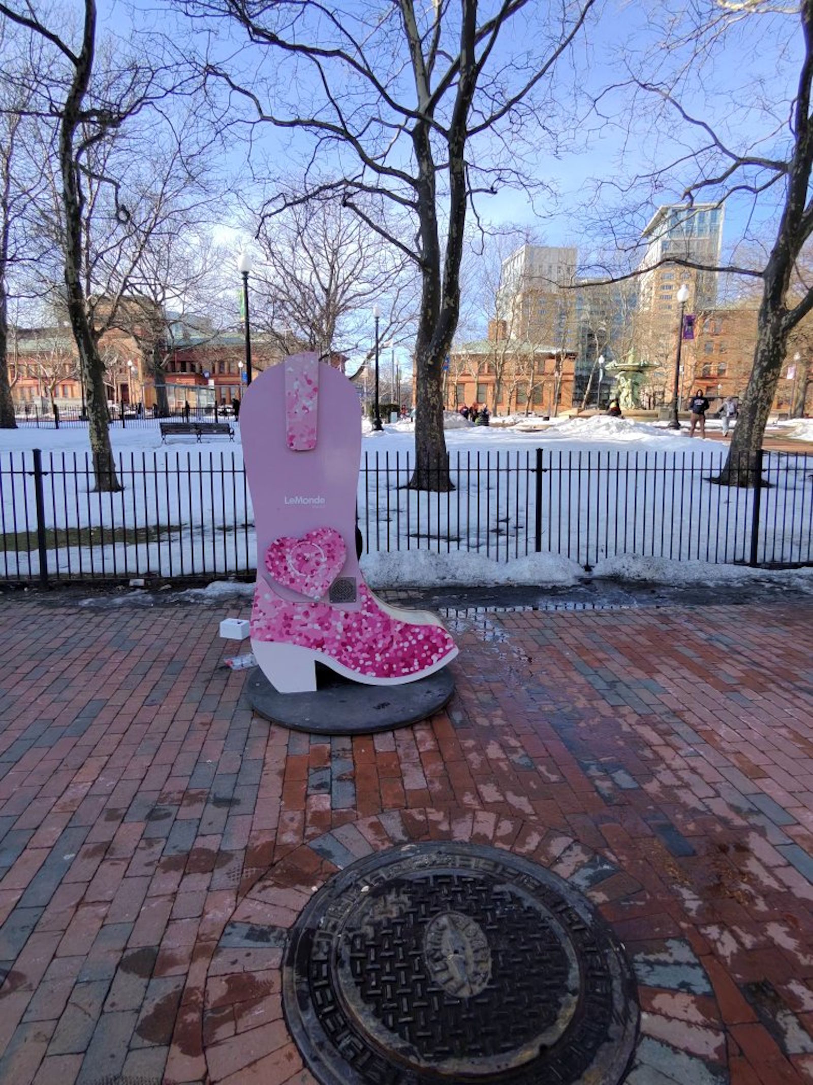 Pink cowboy boot public art installation at Burnside Park in winter snow, Providence, February 2026