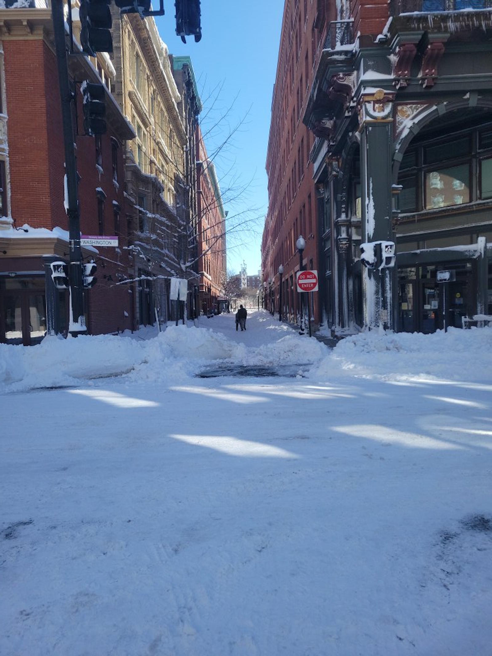 Washington Street Providence after historic blizzard 2026 - Do Not Enter sign, two figures walking through walls of snow
